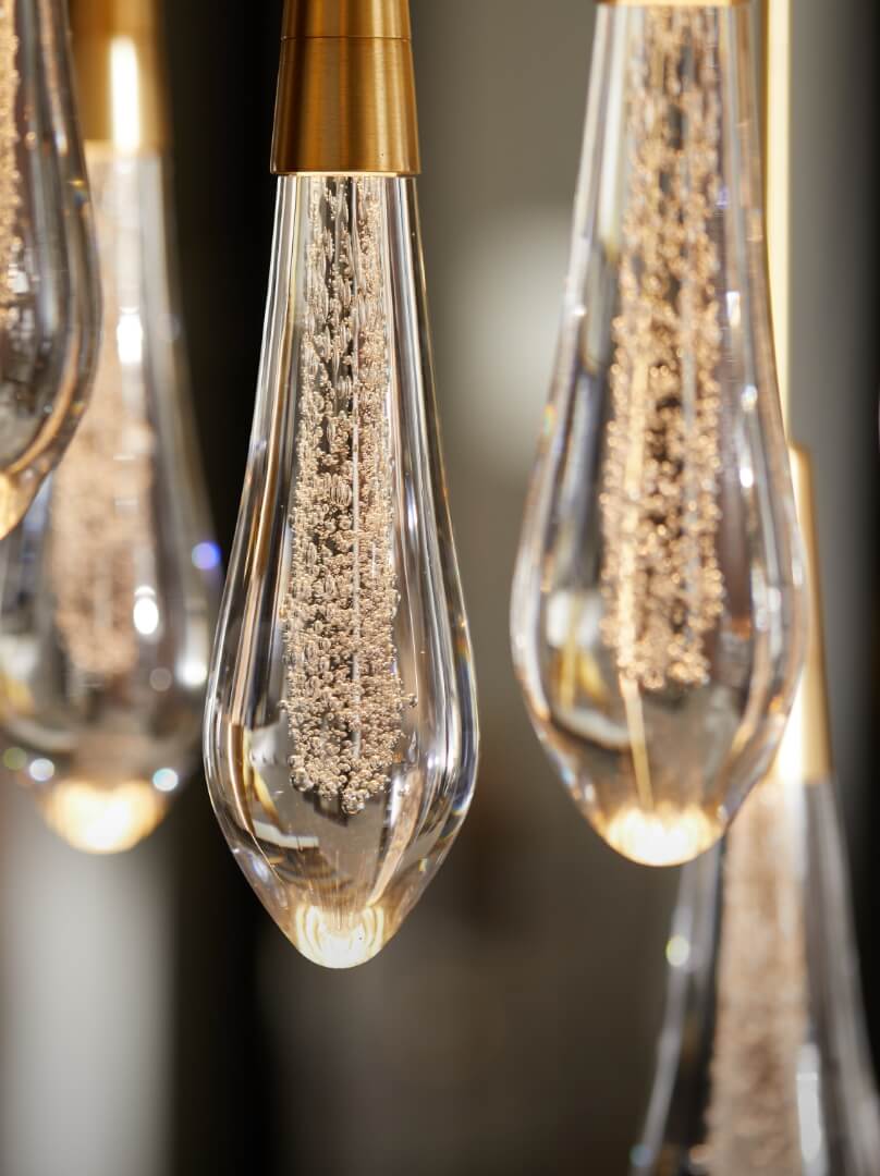 A cluster of transparent glass bulbs suspended from the ceiling.